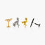 four unique metal pieces, each with a distinct design and color: a gold-colored piece resembling a bird, a silver-colored piece resembling a bird, a gold-colored piece resembling a bird, and a black-colored piece resembling a bird.