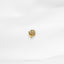 a close up of a gold ring on a white surface