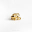 a gold elephant ring sitting on top of a white surface