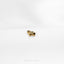a close up of a gold ring on a white surface