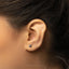 a close up of a person wearing a pair of ear piercings