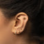 a close up of a person wearing a pair of ear piercings