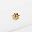 a pair of gold earrings sitting on top of a white surface