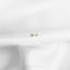 a single gold arrow on a white cloth