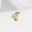 a close up of a gold ring on a white shirt
