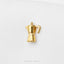 A small gold-colored coffee pot-shaped pendant or brooch is shown against a white background.