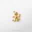A small gold-colored figurine of a voodoo doll is shown against a white background.