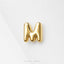 A shiny gold letter 'M' on a white background.