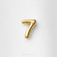 A single, shiny gold number 7 is centered against a plain white background.