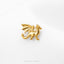 A small golden dragon pin is shown against a white background.