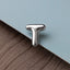 A close-up image of a metallic letter 'T' on a textured surface.