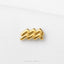 A gold-colored zigzag-shaped object is placed on a white background.