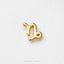 A single, shiny gold-colored charm in the shape of the astrological sign Libra, which is represented by the letters 'L' and 'B'.