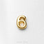 A single, shiny gold number 6 is displayed against a white background.