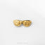 A pair of gold-colored spiral-shaped earrings or earrings is shown against a white background.