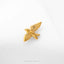 A small golden bird-shaped earring is shown against a white background.