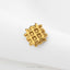 A small gold-colored metal object with a grid-like pattern is shown against a white background.