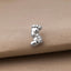 A pair of silver earrings shaped like baby feet, resting on a beige fabric surface.