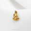A small gold-colored metal object, resembling a bird or a sculpture, is displayed against a white background.