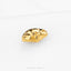 A small, gold-colored frog figurine is shown against a white background.