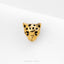 A gold-colored leopard head pin is shown against a white background.