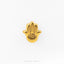 A gold-colored hand with an eye symbol on it, placed against a white background.