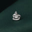 A small silver cup-shaped pin is resting on a textured green fabric.