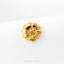 A single, shiny gold flower-shaped earring is displayed against a white background.