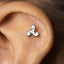 A silver earring with a spiral design is visible in the image.