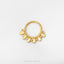 A gold-colored metal ring with a decorative design on it, placed against a white background.