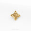 A gold-colored metal piece with a unique, intricate design, resembling a knot or a geometric pattern, is shown against a white background.