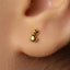 A close-up view of a person's ear with a small gold earring in the earlobe.