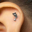 A close-up of a person's ear with a small silver earring in the earlobe.