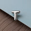 A close-up image of a metallic letter 'T' on a textured surface.