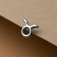 A silver earring in the shape of a zodiac sign, specifically a Taurus, is shown against a beige background.