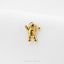 A small golden figurine of a smiling gingerbread man is displayed against a white background.