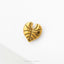 A single, shiny gold leaf-shaped object is displayed against a white background.
