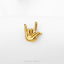 A small gold-colored hand sign is displayed against a white background.