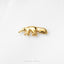 A small gold-colored metal object resembling a fox or similar animal is shown against a white background.