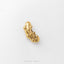 A single, shiny gold-colored object resembling a pickle or cucumber is shown against a plain white background.