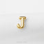 A single, shiny gold letter 'J' is prominently displayed against a plain white background.