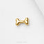 A single, shiny gold-colored bone-shaped object is displayed against a white background.
