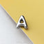 A shiny silver letter 'A' is placed on a yellow background.