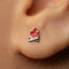 A close-up of a person's ear with a small, red earring featuring a flame design.