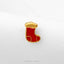 A small red and gold pin or badge is displayed against a white background.
