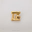 A gold-colored metal object resembling a mixer or blender is shown against a white background.
