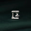 A silver-colored kitchen appliance, possibly a mixer or blender, is the central focus of the image, set against a dark green background.