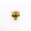 A close-up image of a golden tiger head pin against a white background.