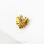 A single, shiny gold leaf-shaped object is displayed against a white background.