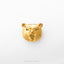 A golden bear head pin is shown against a white background.